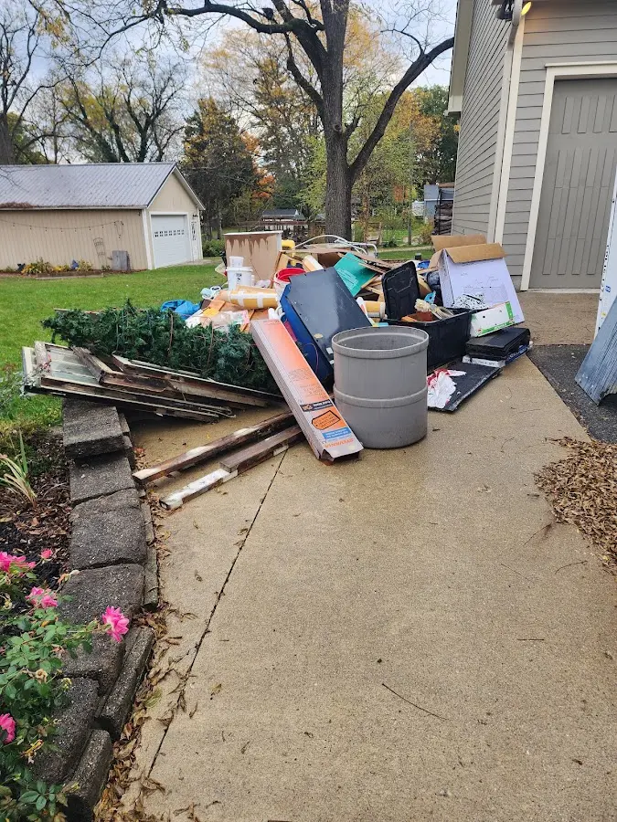 Dumpster being loaded with debris for Estate Cleanout Dumpster Rental in Lockhart